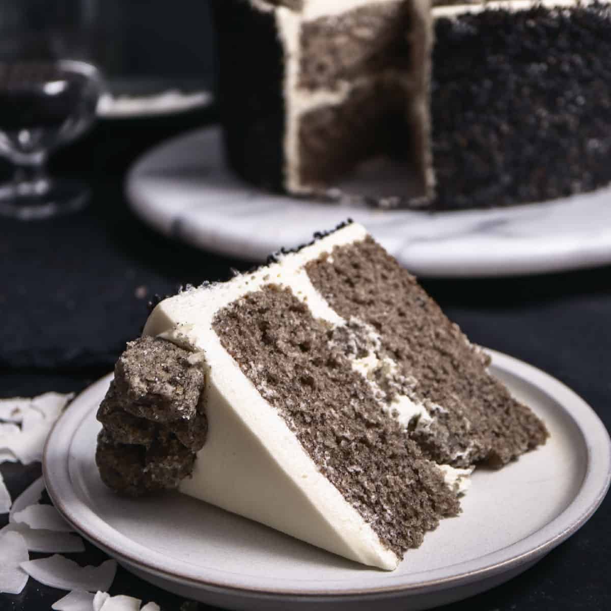 slice of grey and white cake on a white round plate