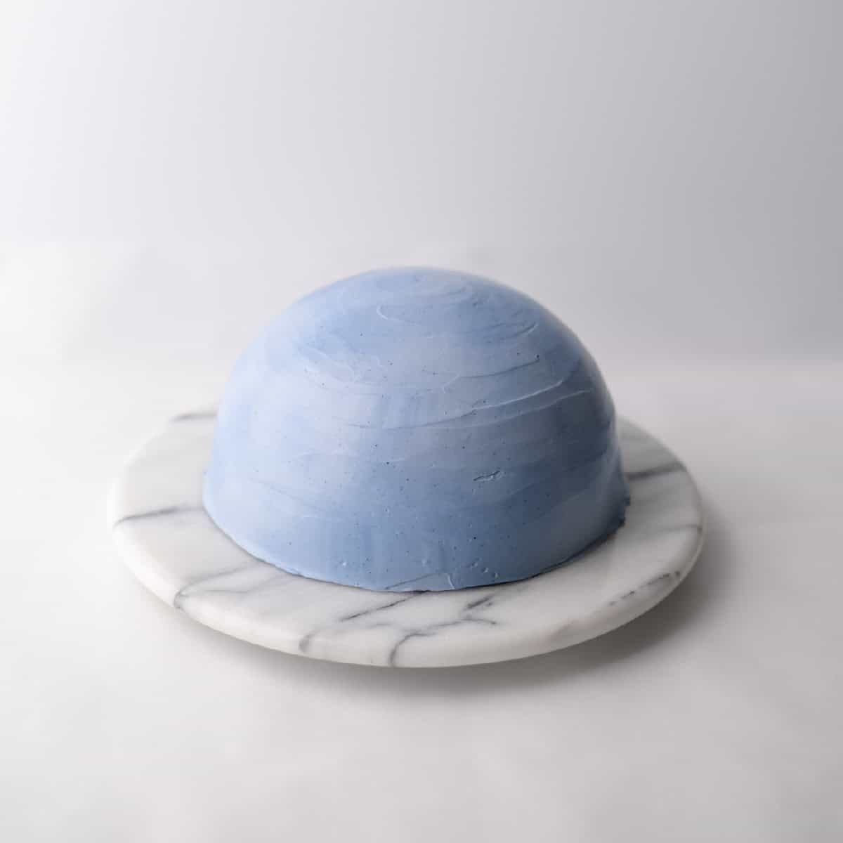 blue dome cake on a marble lazy susan
