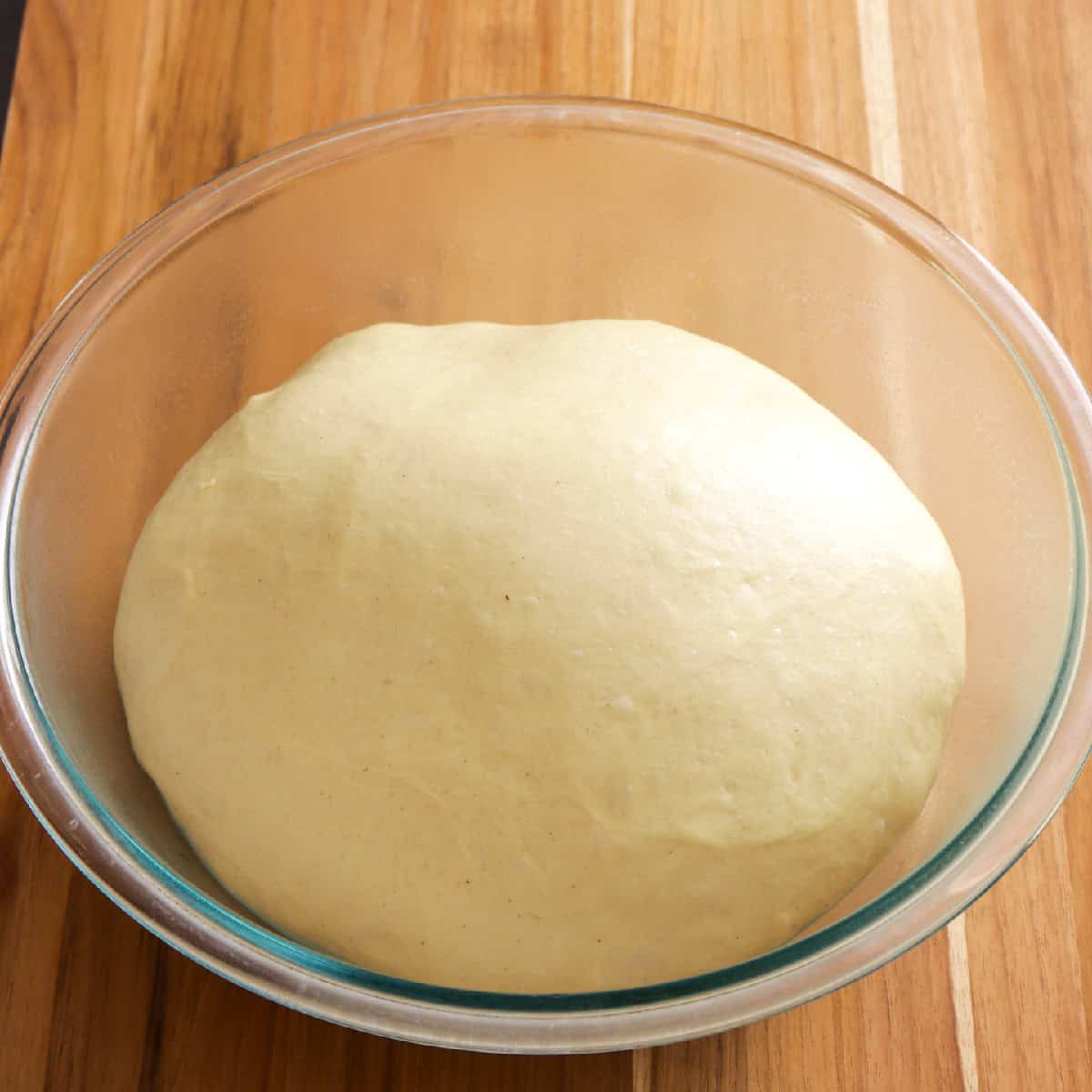 proofed dough in large glass bowl